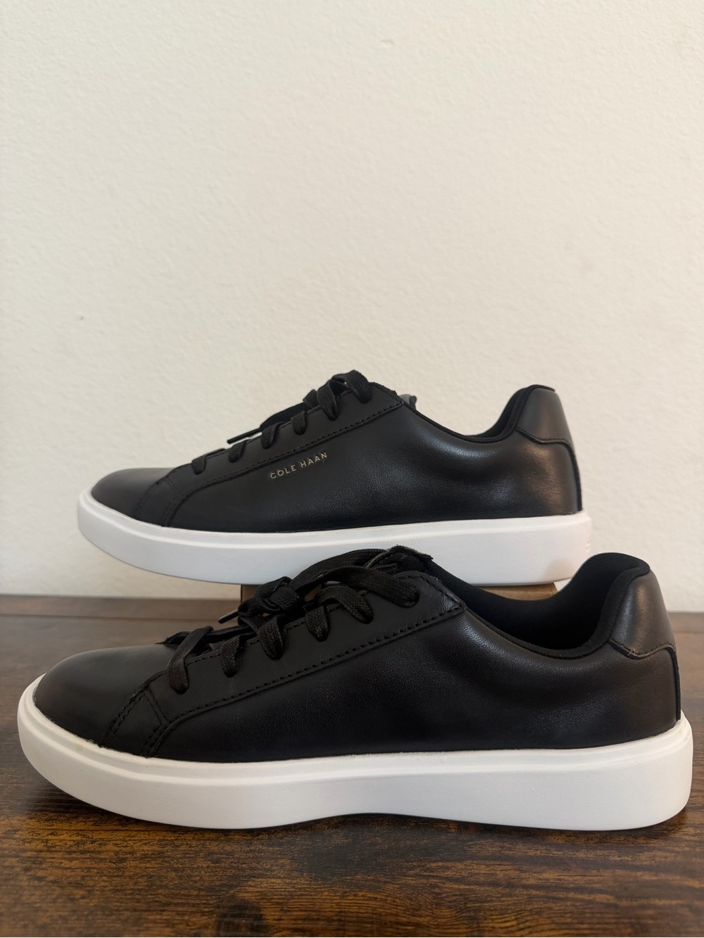 Cole Haan women’s Black Leather Low-Profile Sneakers with White Sole